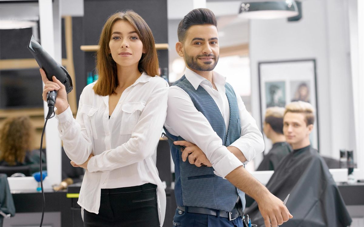 Hair stylists with a blow dryer and scissors in a salon